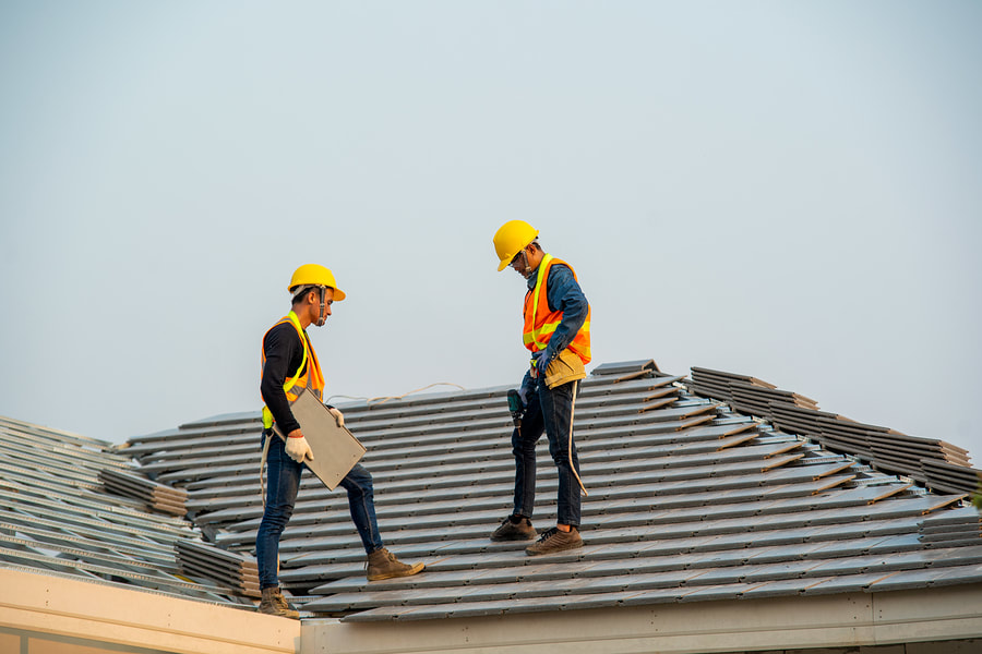 men fixing a roof